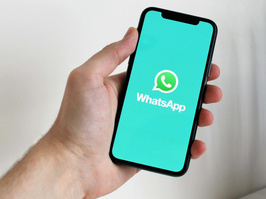Person hält Smartphone mit WhatsApp in der Hand