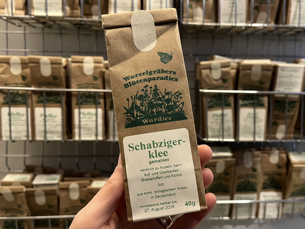 Tüte Schabzigerklee Gewürz vor Gewürzregal